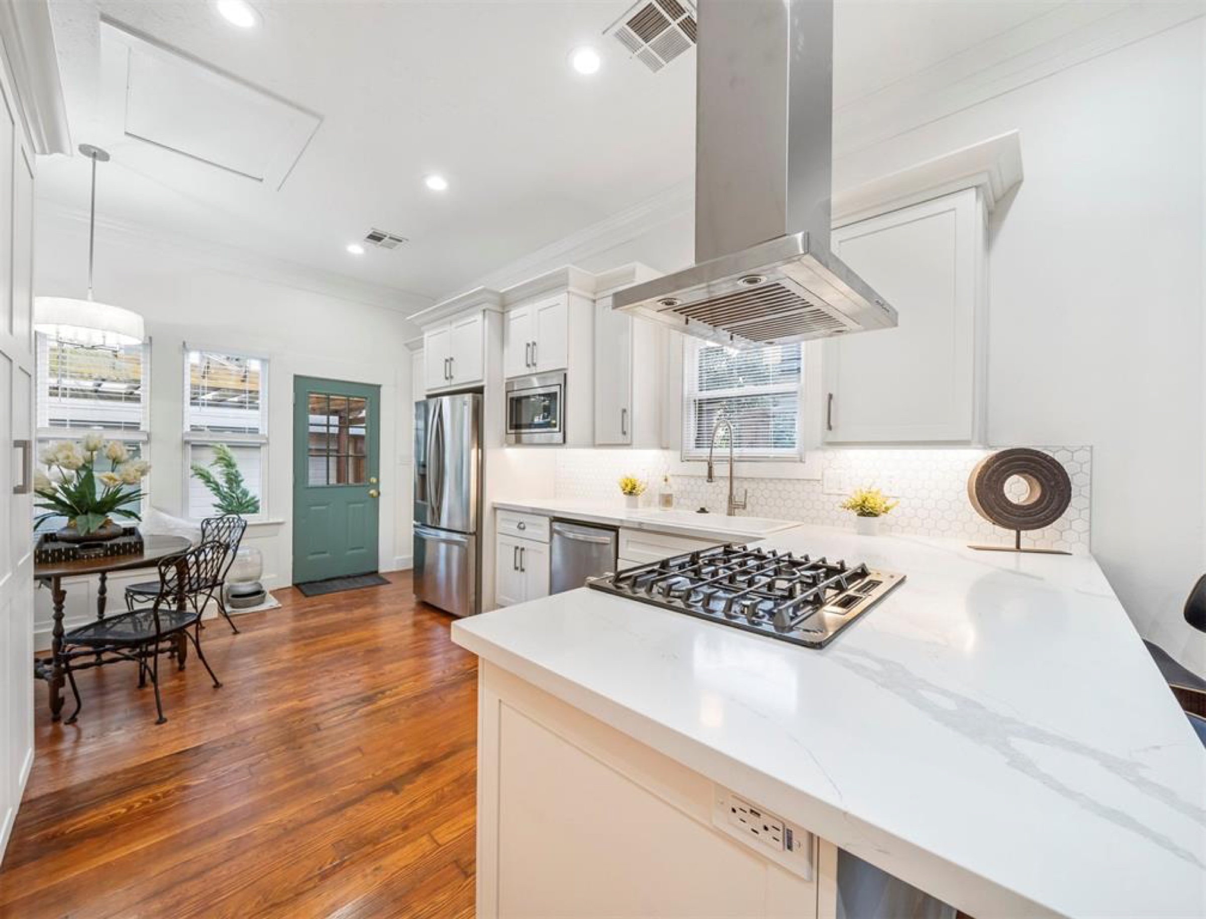 White kitchen remodel with range hood and island — Matt Baker Contracting